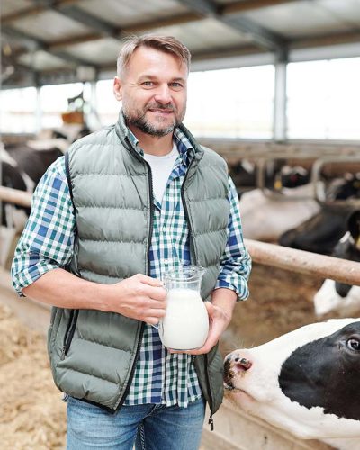 happy-young-worker-of-dairy-farm-holding-jug-with-resize.jpg